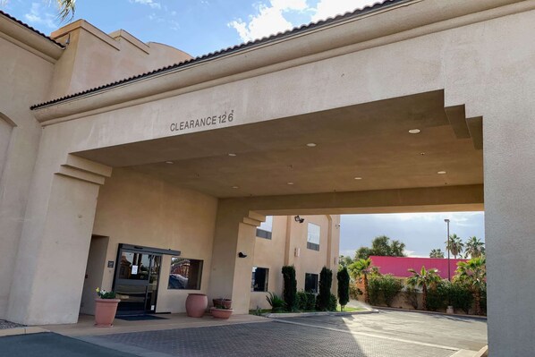 A building entrance with a clearance sign, a glass door, and potted plants. - Days Inn by Wyndham Blythe (Blythe)