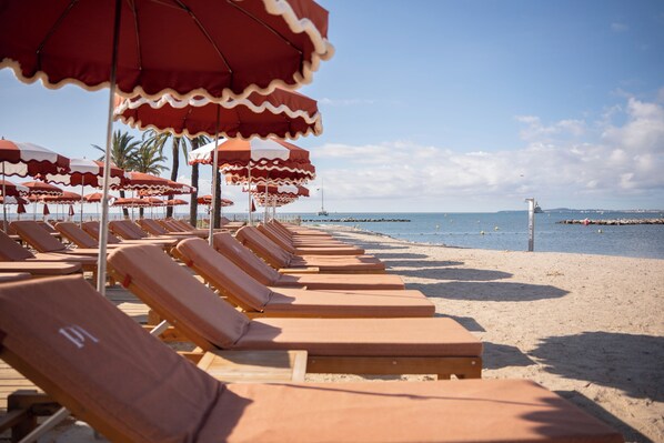 Private beach, white sand, sun loungers, beach umbrellas