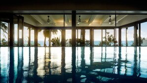 A large indoor swimming pool with clear views of the ocean and palm trees. - Marbella Club Hotel Golf Resort & Spa (Marbella)
