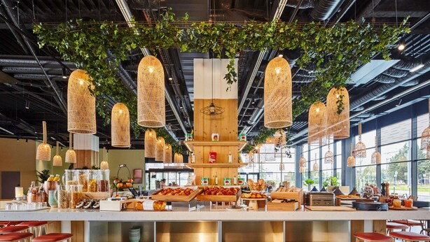 A modern cafe with a central counter, hanging wicker lamps, and a checkered floor. - Mercure Paris Orly Airport (Paray-Vieille-Poste)