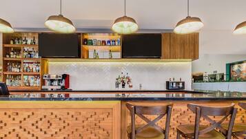 Un área de bar con paneles de madera, taburetes y una variedad de botellas de licor.