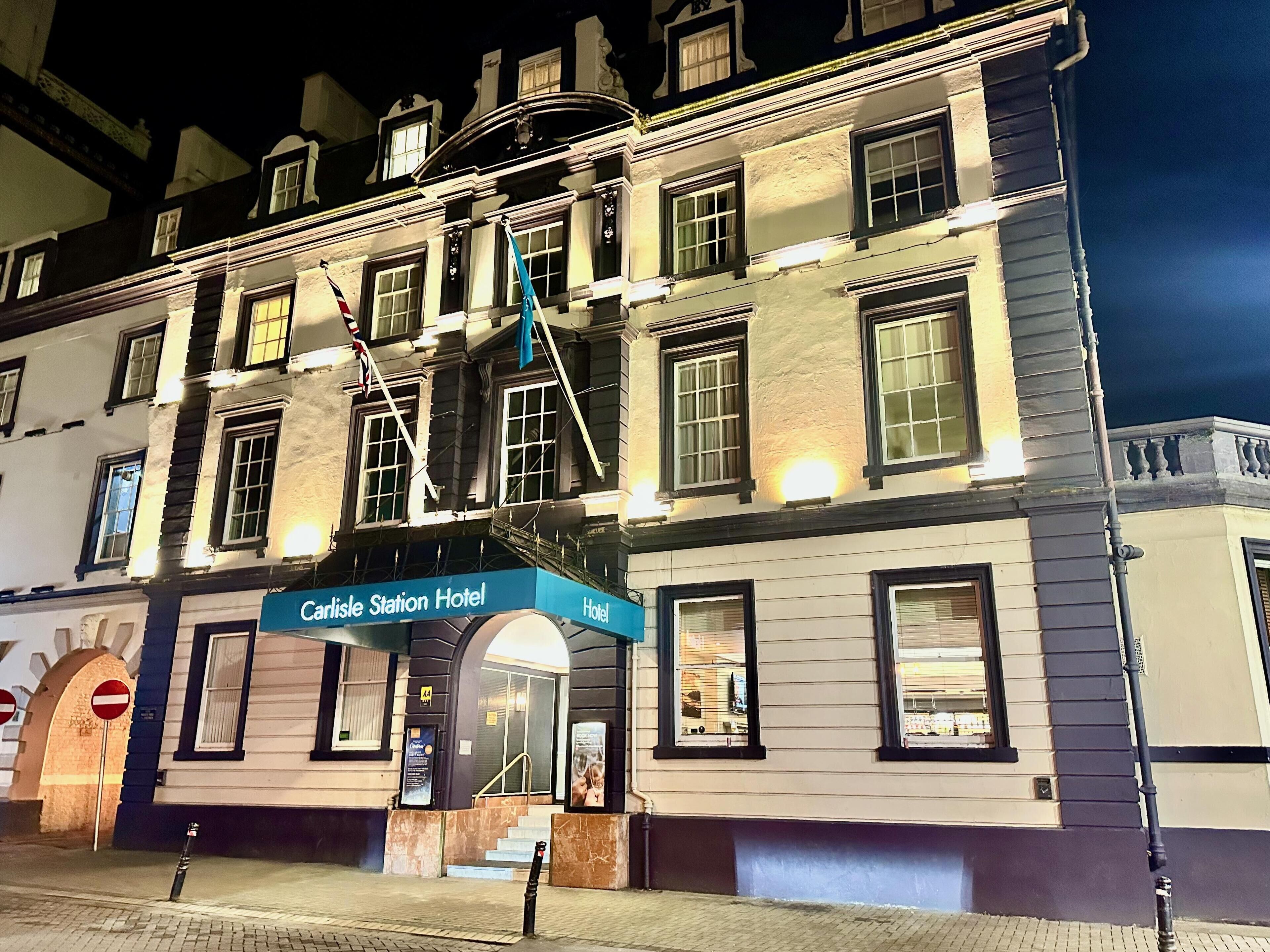 A historic building with a sign reading "Carlisle Station Hotel."