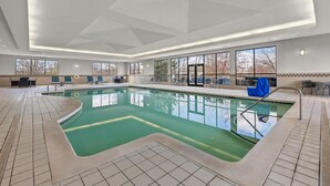 An indoor swimming pool with clear glass walls, a tiled floor, and a ceiling with recessed lighting. - Hampton Inn Toledo-South/Maumee (Maumee)