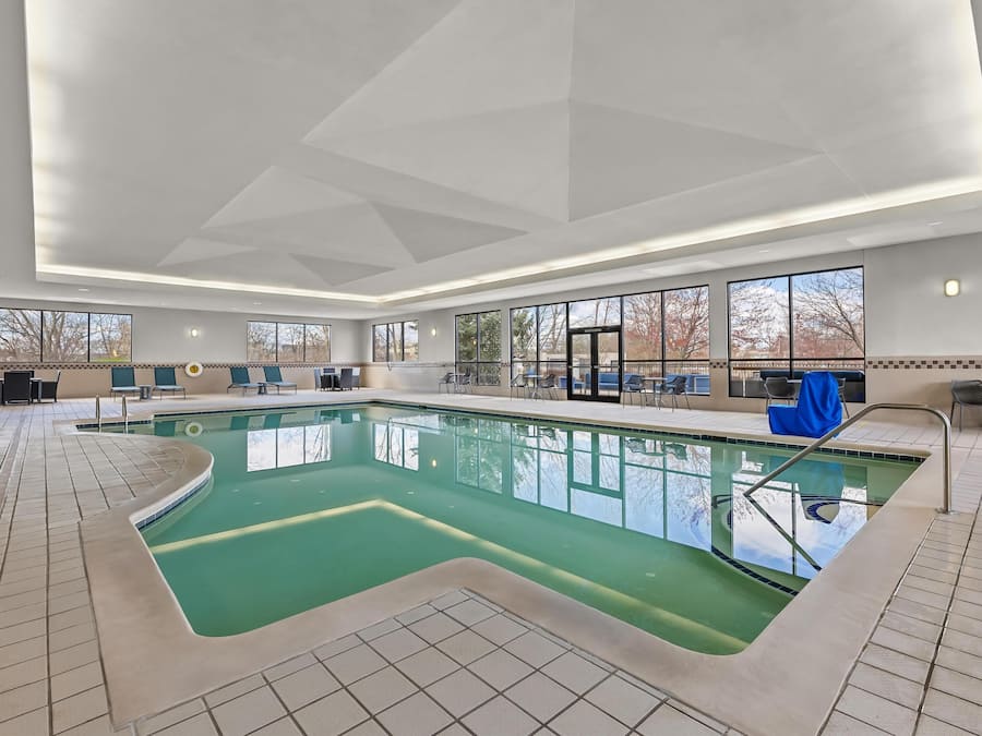 Indoor pool, open 9:00 AM to 10:00 PM, pool umbrellas, pool loungers
