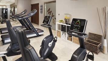 A gym with multiple treadmills and an elliptical machine.