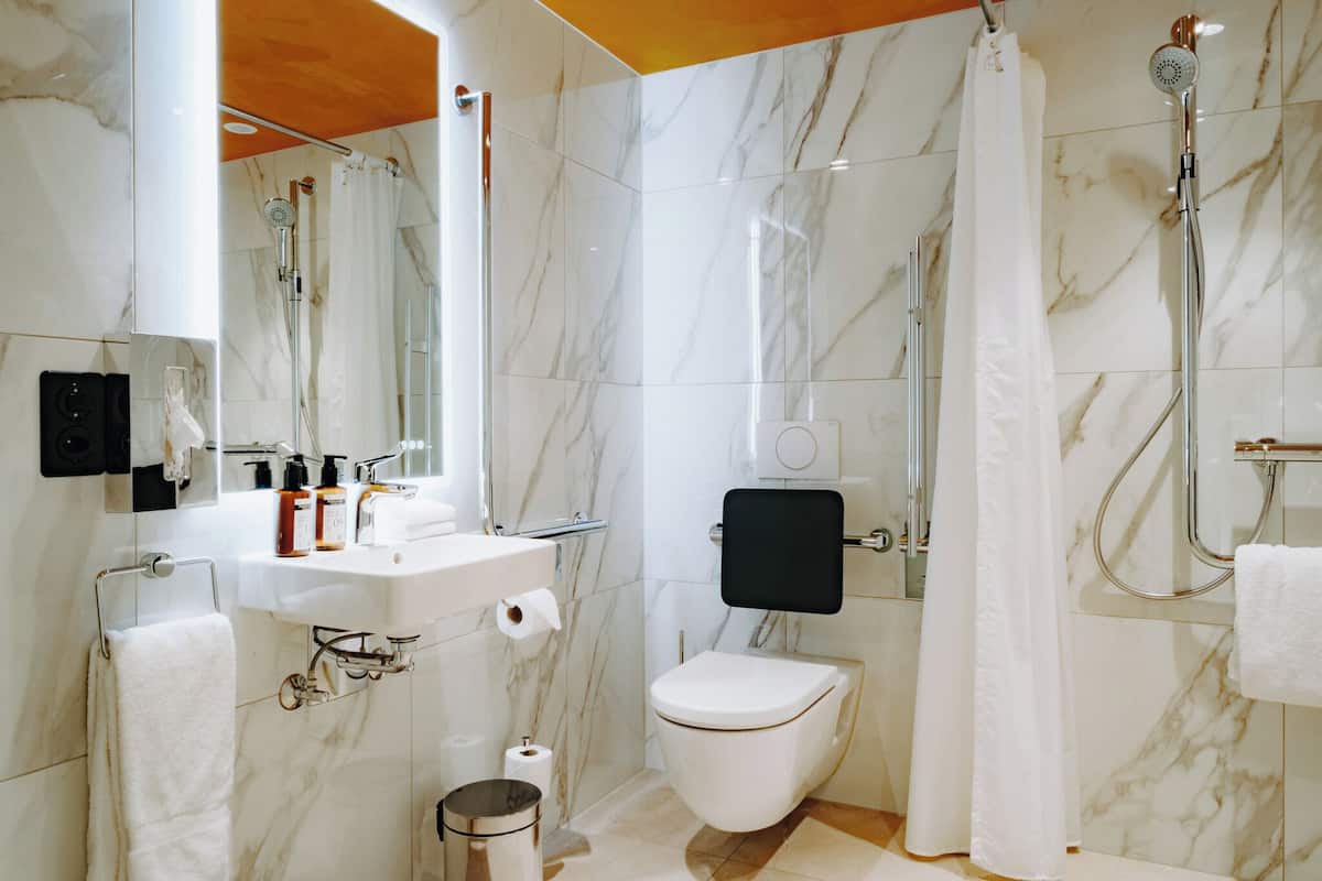 comfort room | bathroom | combined shower/bathtub, hair dryer, towels, soap