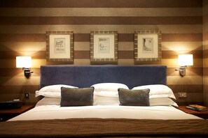 Habitación ejecutiva | Ropa de cama de alta calidad y minibar 