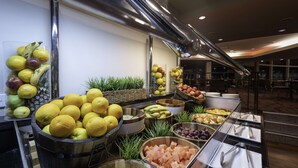 A buffet with various fruits and vegetables, including bananas, lemons, and grapes. - DoubleTree by Hilton Hotel Cairns (Cairns)