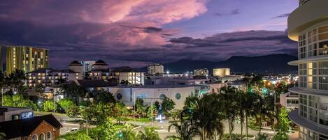 A hotel with a modern design, featuring a prominent dome structure and a rooftop terrace.