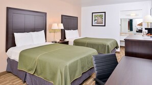 A hotel room with two beds, a desk, and a chair. - Americas Best Value Inn Clute Lake Jackson (Clute)
