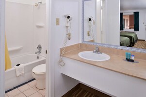 Un baño con bañera, inodoro y lavamanos.