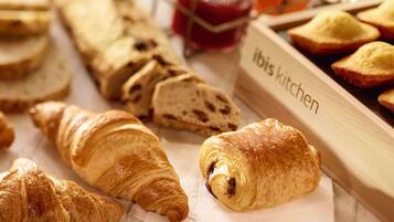 Une variété de produits de boulangerie, notamment des croissants et du pain, avec une étiquette indiquant « Cuisine ibis ».