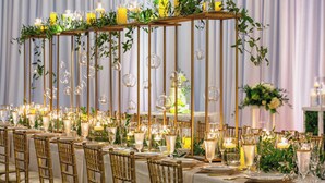 A banquet hall with long tables set for a formal event, featuring gold chairs, white tablecloths, and elegant glassware. - Charlotte Marriott City Center (Charlotte)