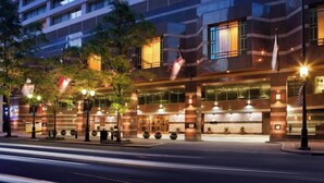 A modern hotel with a prominent entrance, large windows, and a well-lit facade. - Charlotte Marriott City Center (Charlotte)