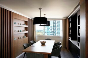 A modern dining area with a wooden wall, a large window, and a view of a cityscape. - Charlotte Marriott City Center (Charlotte)