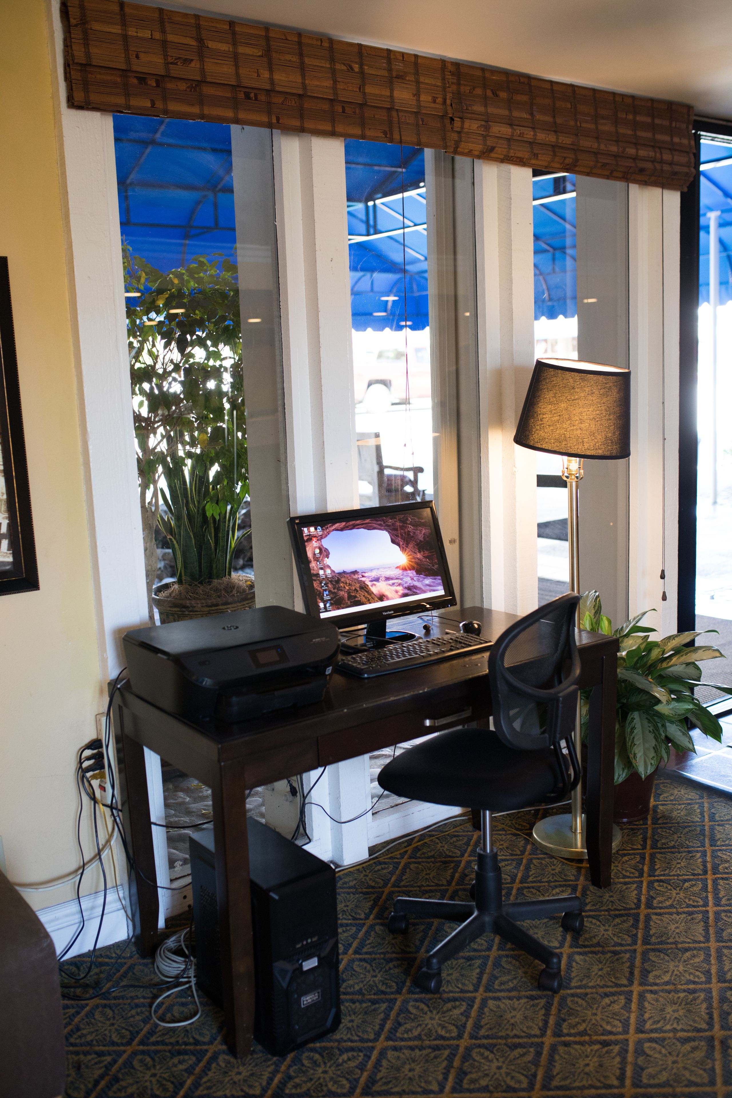 A home office setup with a computer, chair, and desk.