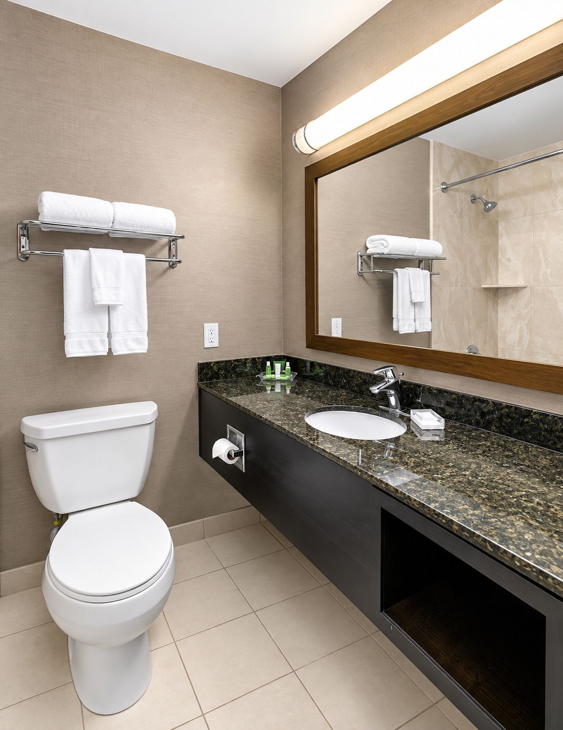 A modern bathroom with a toilet, sink, and towel rack.