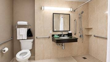 A modern bathroom with a toilet, sink, and shower.
