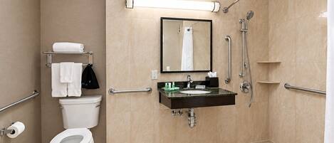 A modern bathroom with a toilet, sink, and shower.