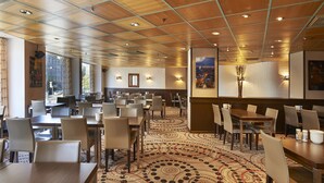 A spacious restaurant with a wooden ceiling, patterned carpet, and multiple dining areas. - Scandic Kaisaniemi (Helsinki)