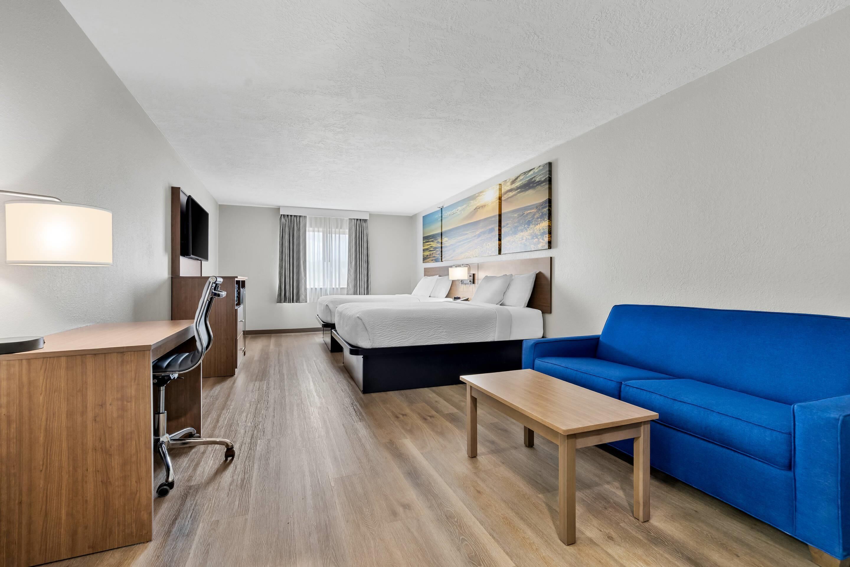 Suite, Multiple Beds, Non Smoking | Desk, laptop workspace, blackout drapes, iron/ironing board