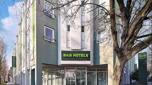 A B&B hotel with a modern facade, large glass entrance, and a visible sign. - B&B Hotel Bonn-City (Bonn)