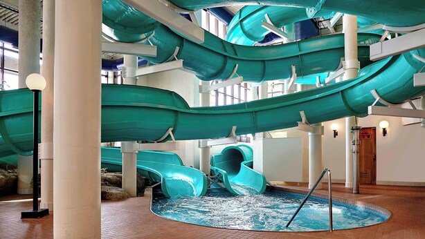 A multi-level indoor water slide structure with a pool at the bottom. - Sheraton Cavalier Calgary Hotel (Calgary)