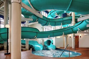 A multi-level indoor water slide structure with a pool at the bottom. - Sheraton Cavalier Calgary Hotel (Calgary)