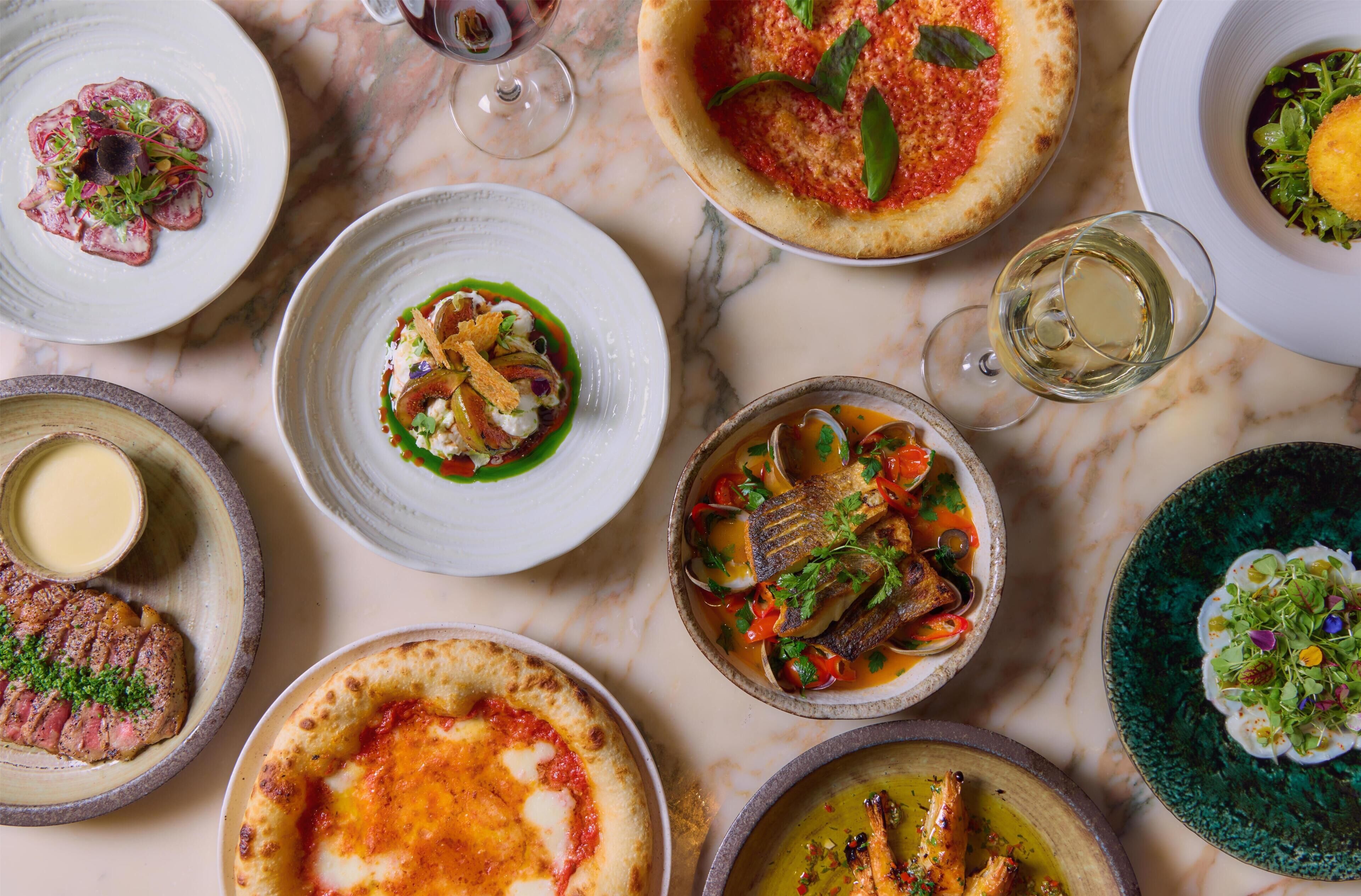 A variety of dishes on a marble table.