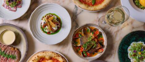 A variety of dishes on a marble table.