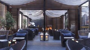 An outdoor seating area with wicker furniture and lanterns.