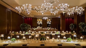A banquet hall with multiple tables set for dining, chandeliers, and candles. - The May Fair Hotel, Mayfair, London (London)