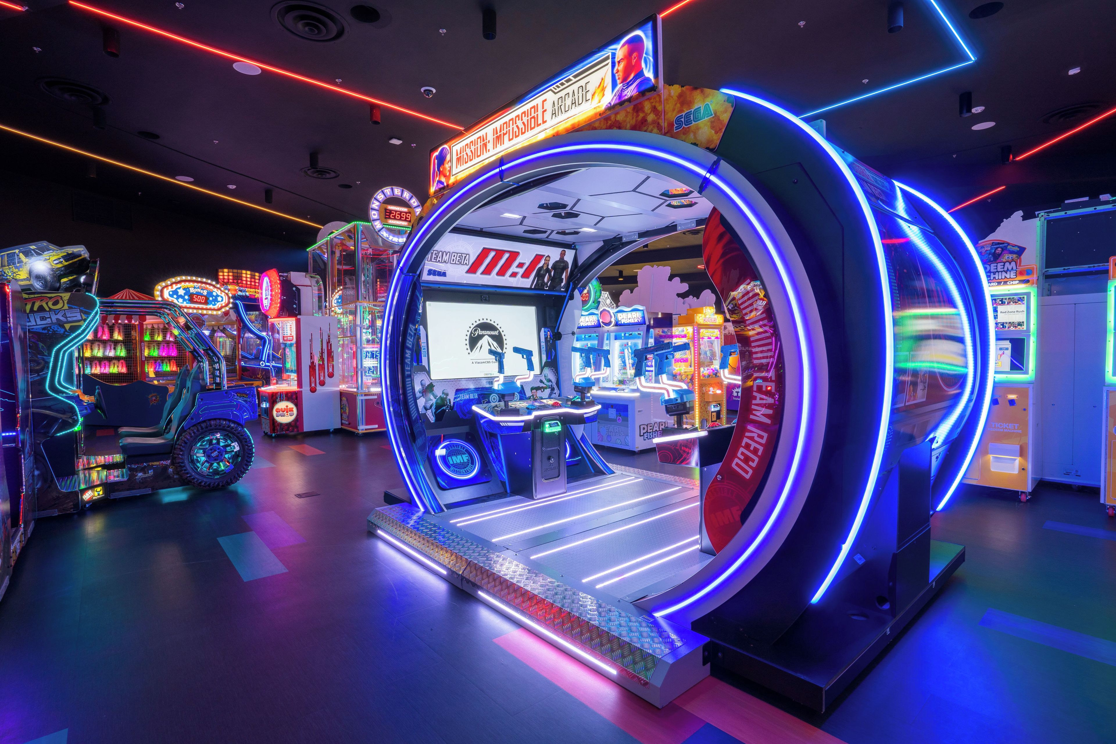 An arcade with neon lights and various gaming machines.