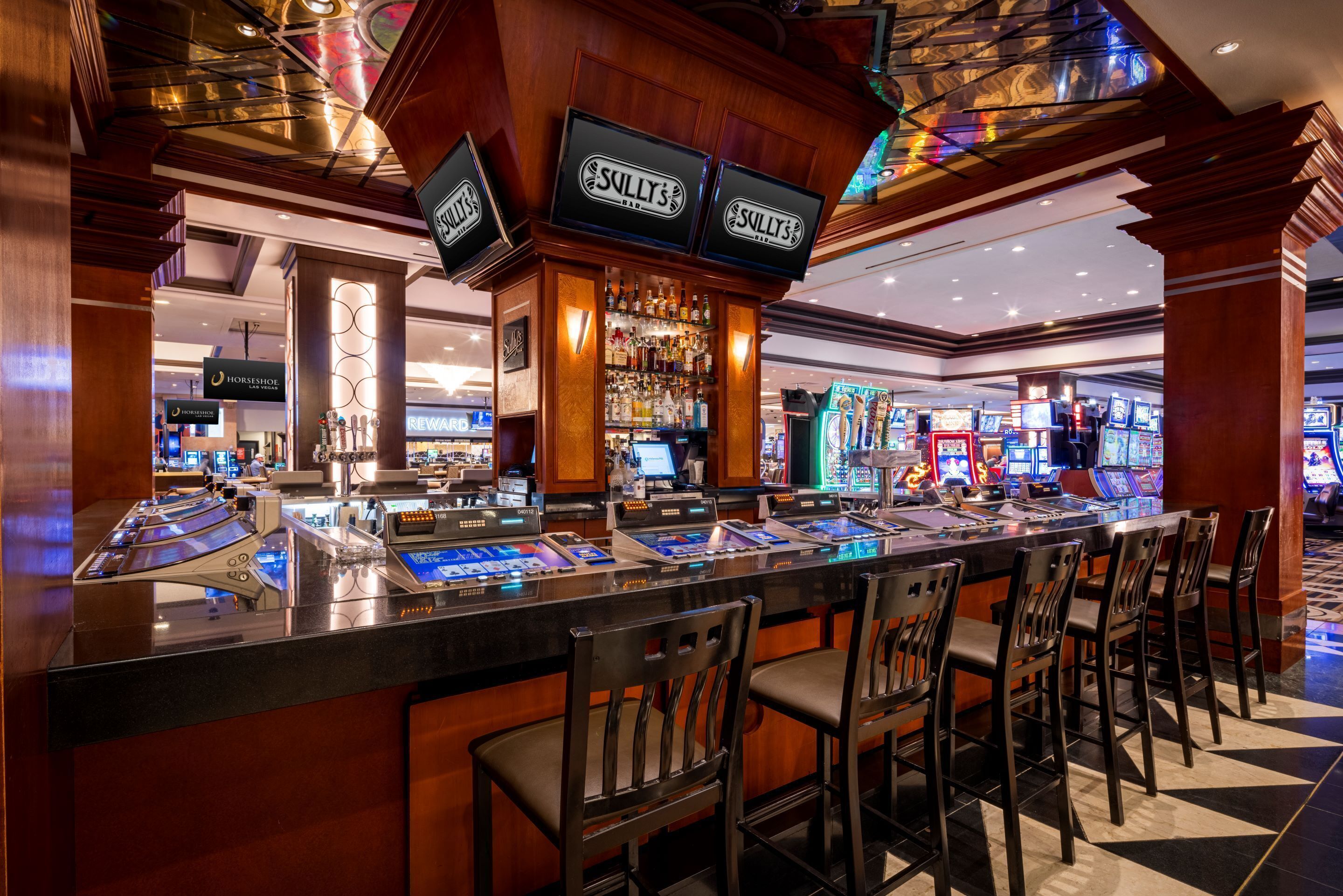 A bar area with multiple gaming machines and a well-lit, modern design.