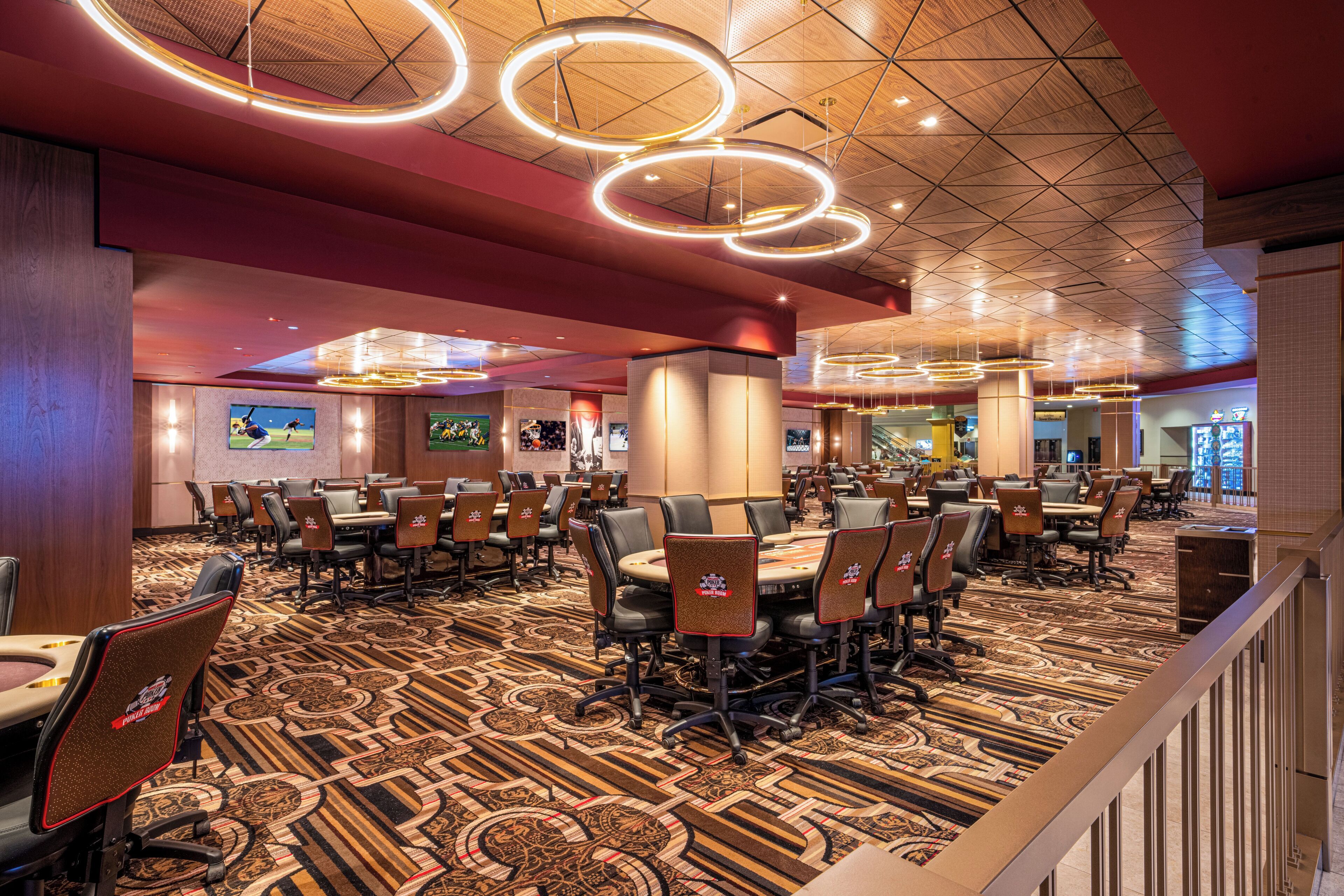 A conference room with round tables, chairs, and a patterned carpet.