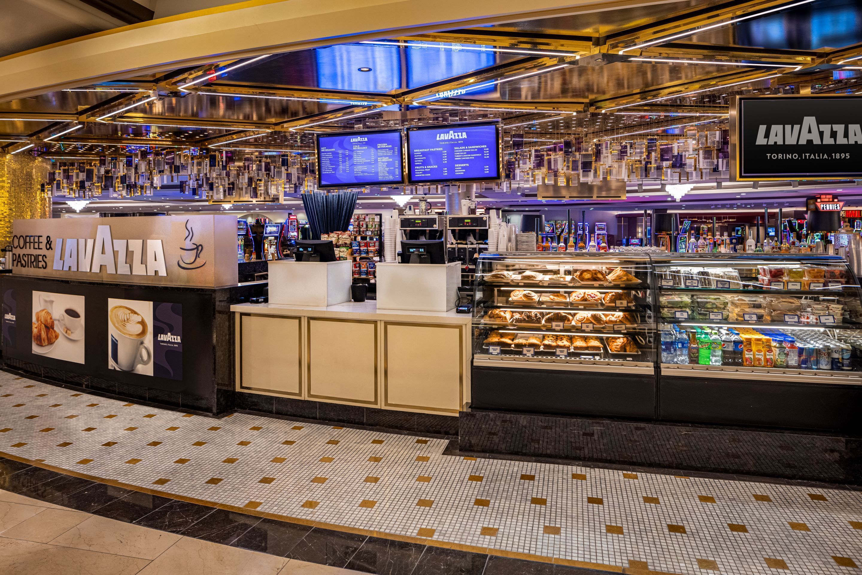 A Lavazza coffee shop with a counter, display cases, and digital menu boards.
