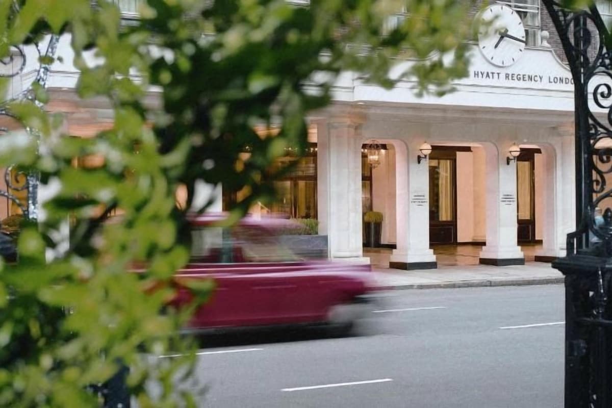 A building with a sign reading 'HYATT REGENCY LONDON' and a street in front.