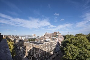 A cityscape with historic buildings, a clear sky, and a prominent tower in the distance. - Hyatt Regency London The Churchill (London)