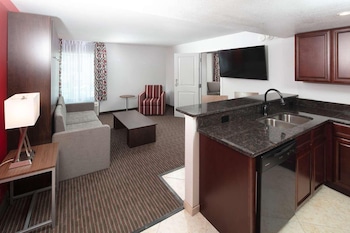 In-room safe, blackout drapes, iron/ironing board at Radisson Hotel Orlando Lake Buena Vista South