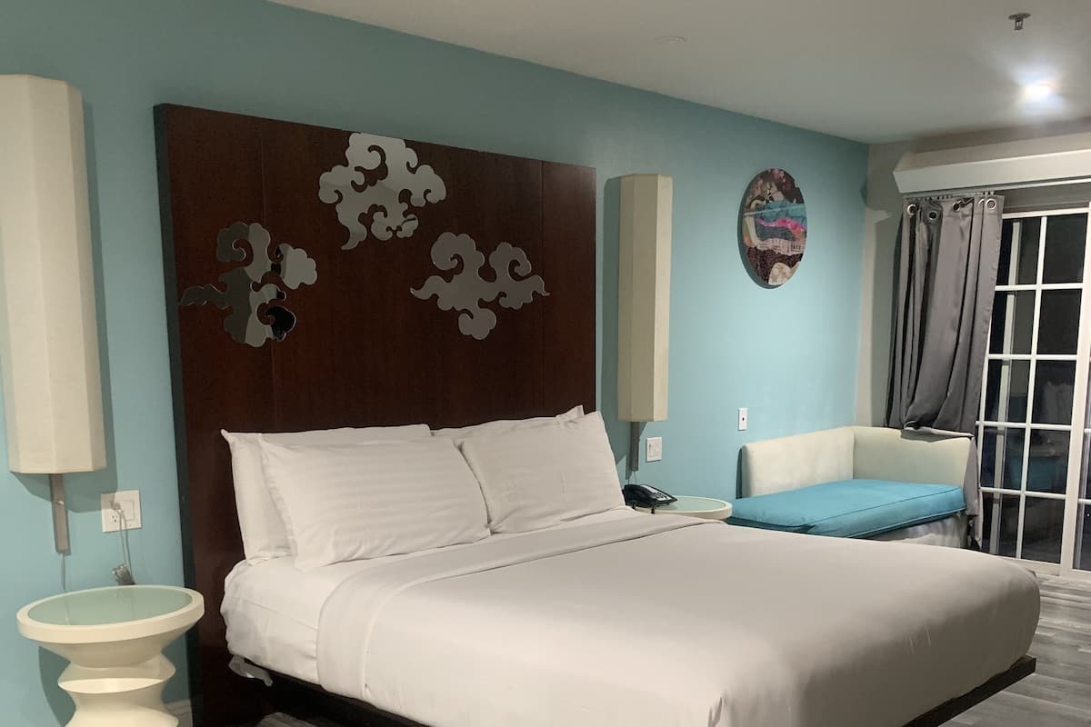 Desk, laptop workspace, iron/ironing board, bed sheets