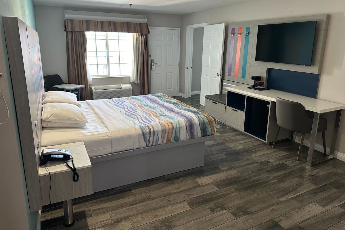 Desk, laptop workspace, iron/ironing board, bed sheets