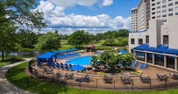 Indoor pool, seasonal outdoor pool, pool umbrellas, sun loungers at Hilton Chicago/Oak Brook Hills Resort & Conference Center