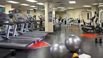 A gym with treadmills, exercise balls, and weight machines.