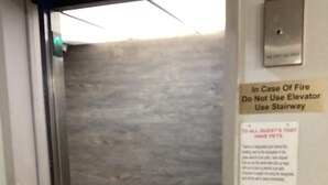 An elevator interior with a sign advising to use the stairway in case of fire. - Motel 6 Bridgeview, IL (Bridgeview)