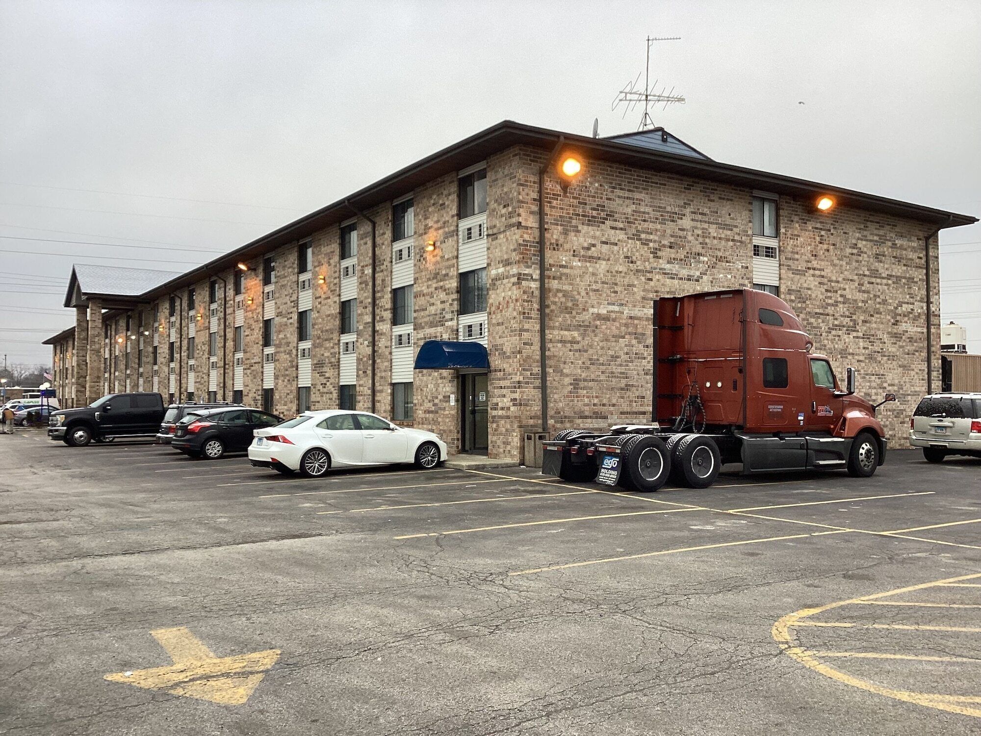 A building with a brick facade, multiple windows, and a flat roof.