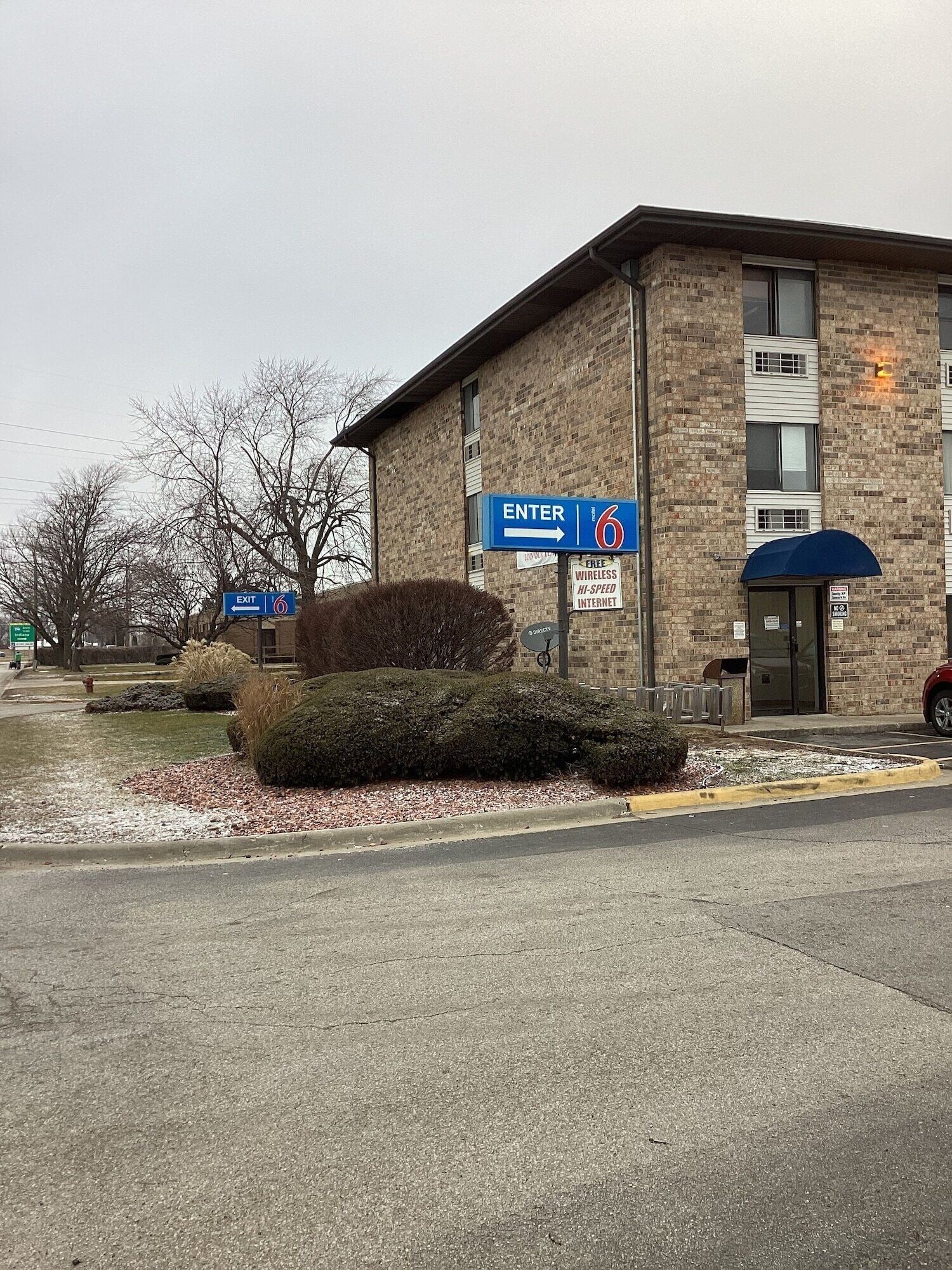 A building with a sign indicating an entrance and exit.