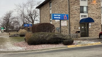 A building with a sign indicating an entrance and exit.
