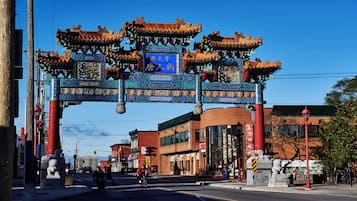 A traditional Chinese gate with intricate designs and a clear blue sky.