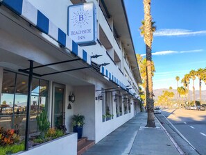 A beachfront hotel with a sign reading "Beachside Inn."