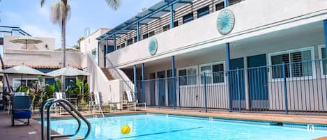 Outdoor pool, a heated pool, open 9:00 AM to 9:00 PM, pool umbrellas